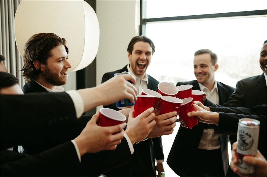 Groom and his groomsmen sharing some drinks together before heading over to the venue