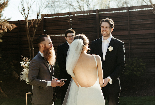 Groom smiling ear to ear at his bride during their wedding at one of the best wedding venues in Nashville 