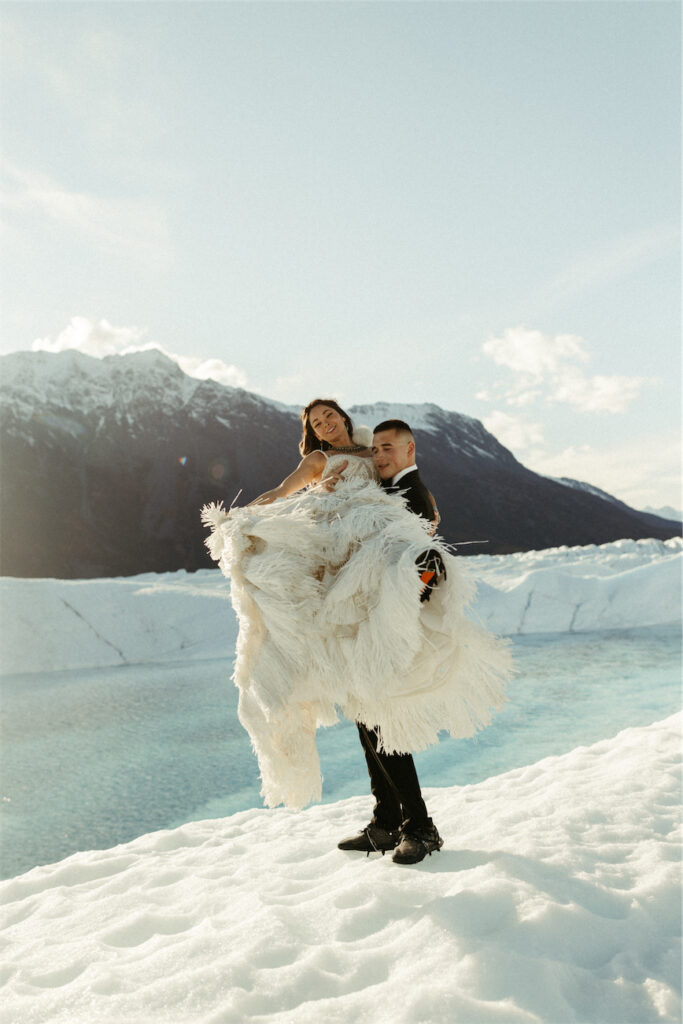 Couple surrounded by fields of ice and mountains in Alaska