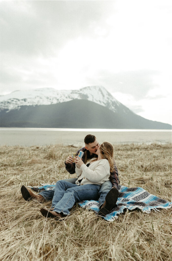 couple kissing with the mountains next to them 