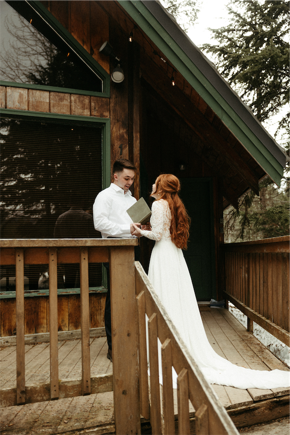 Couple reading aloud vows to one another during their Girdwood alaska elopement ceremony