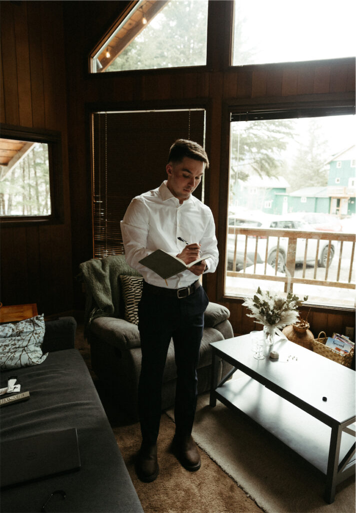Groom writing his vows for his elopement in Girdwood, Alaska