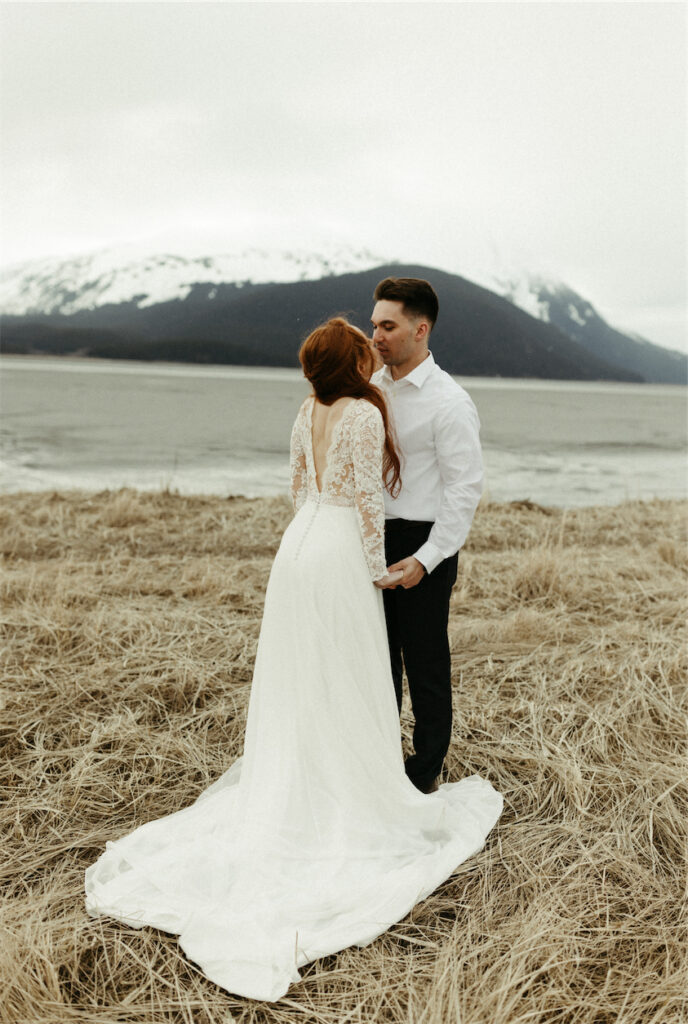 Couple kissing next to the mountains during their elopement in Girdwood, Alaska