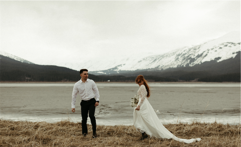 Couple standing next to the mountains in Girdwood, Alaska