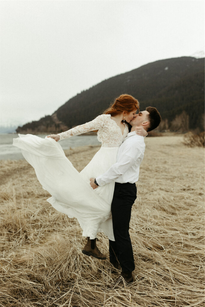 Man picking up woman during an elopement in Girdwood, Alaska