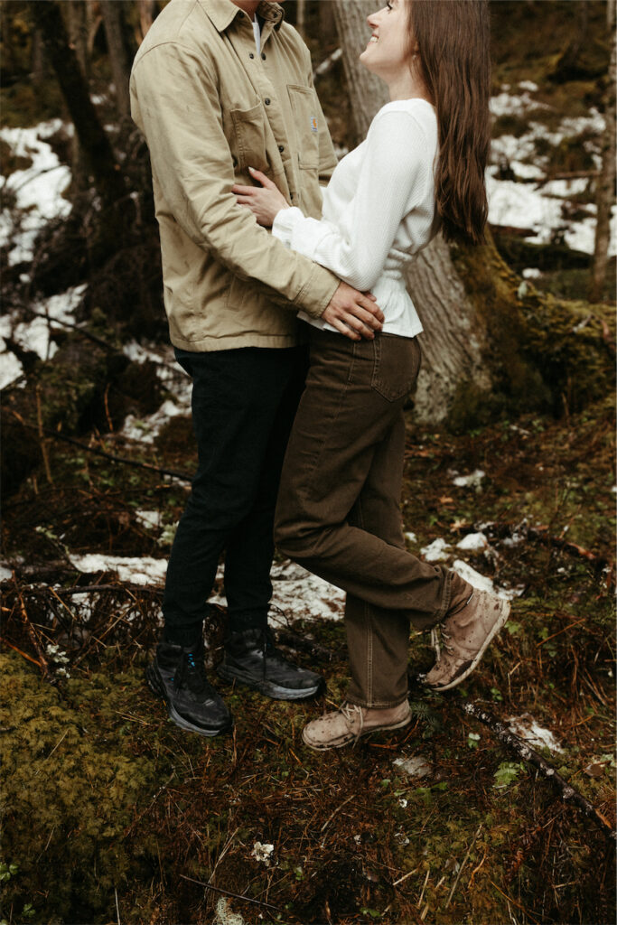 Couple wearing cute outfits during their Alaska engagement photod