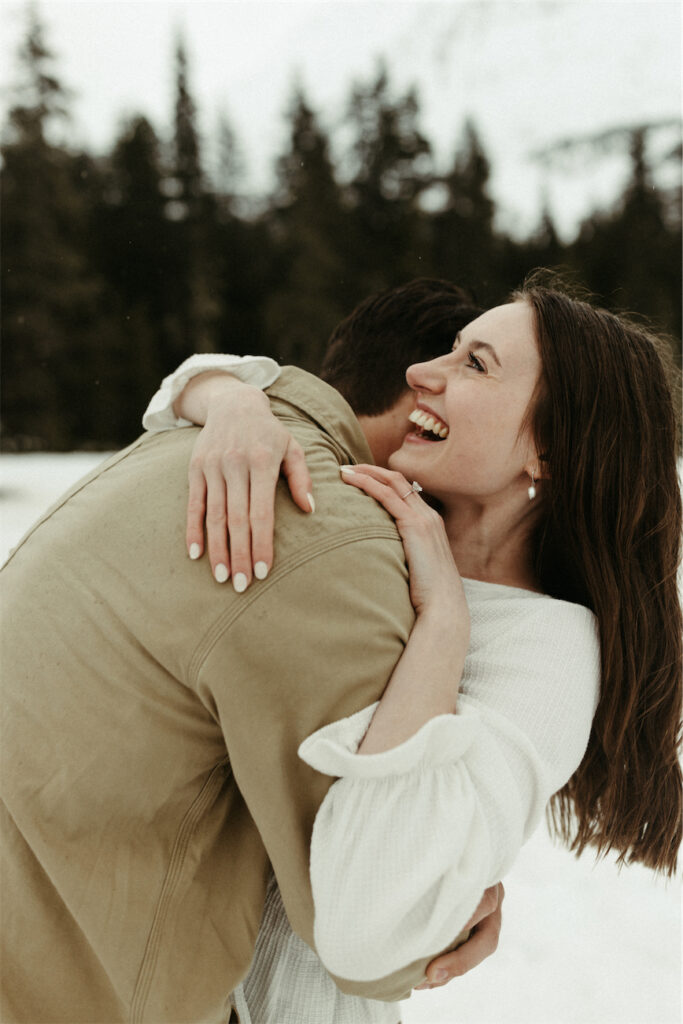 Couple smiling together during their spring engagement session in Girdwood, Alaska