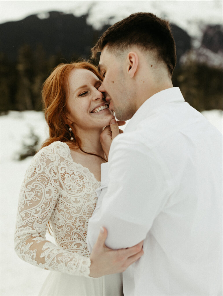 Man kissing woman during his adventure elopement in Girdwood, Alaska