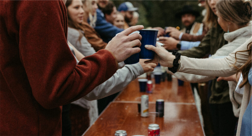 People playing flip cup under the midnight sun