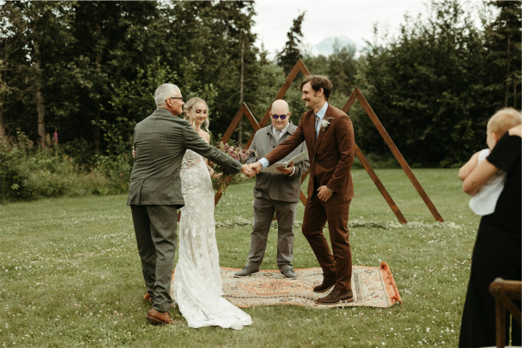 Father of the bride giving his daughter away during her wedding ceremony