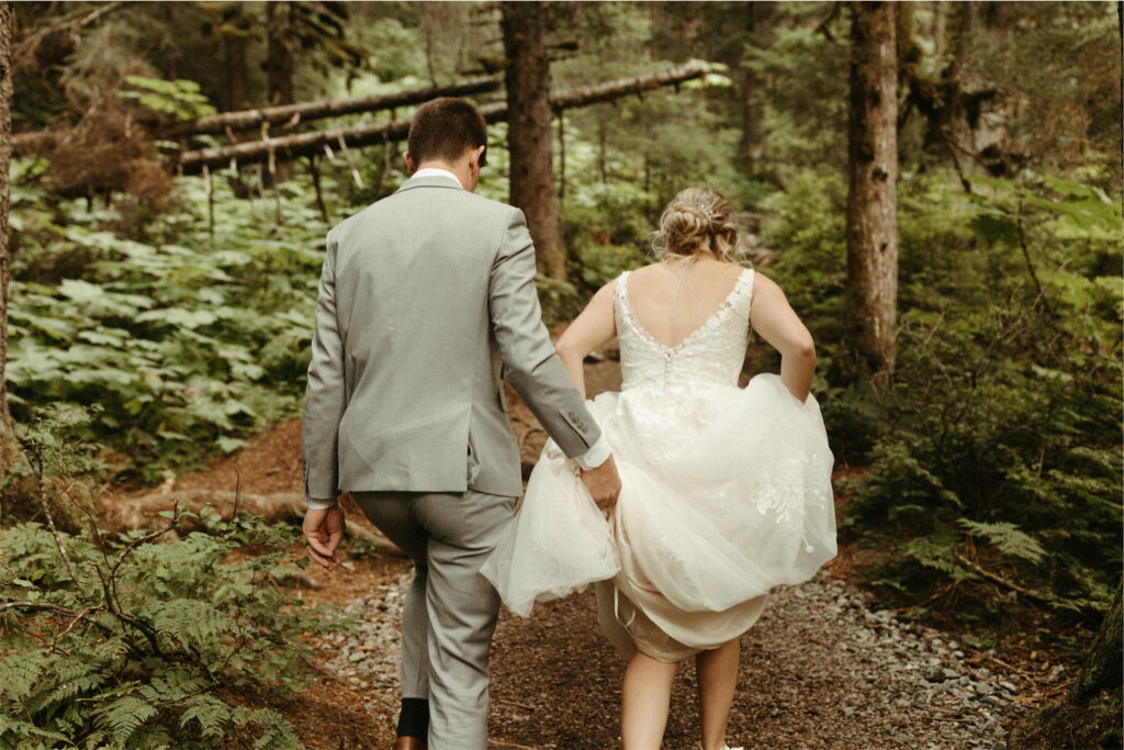 couple walking through the woods during their Alaska elopement 