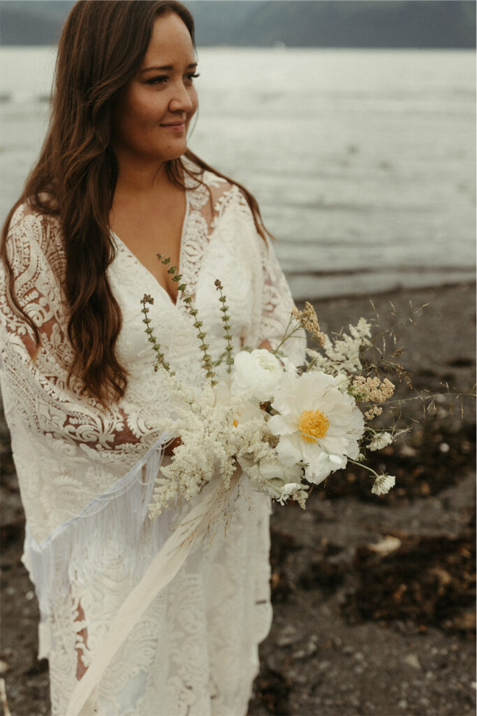 Woman holding flowers after eloping in Seward Alaska