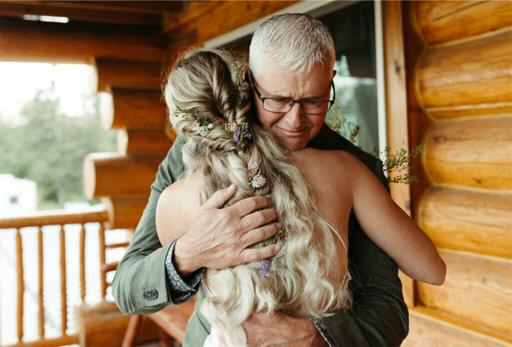 Father of the bride holding his daughter after their first look 