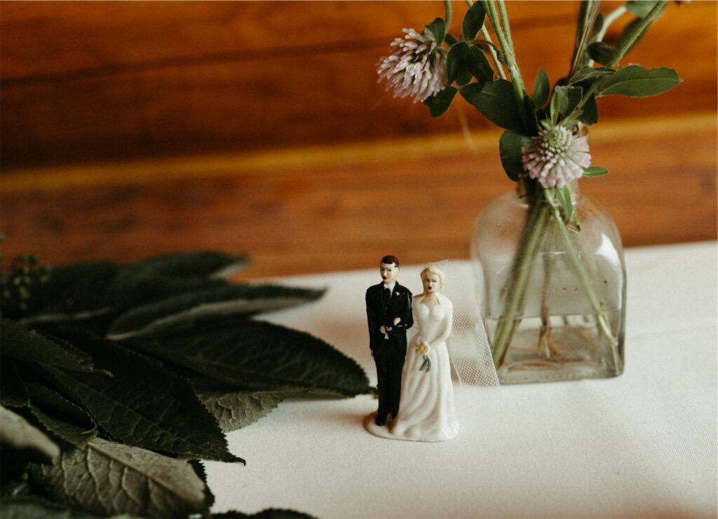 A vintage wedding cake topper sitting on a table