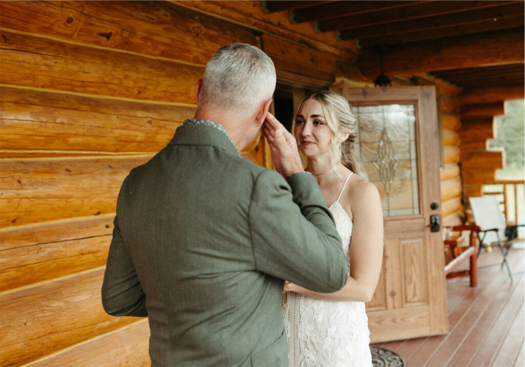 Brides father wiping a tear from his eye after their first look 