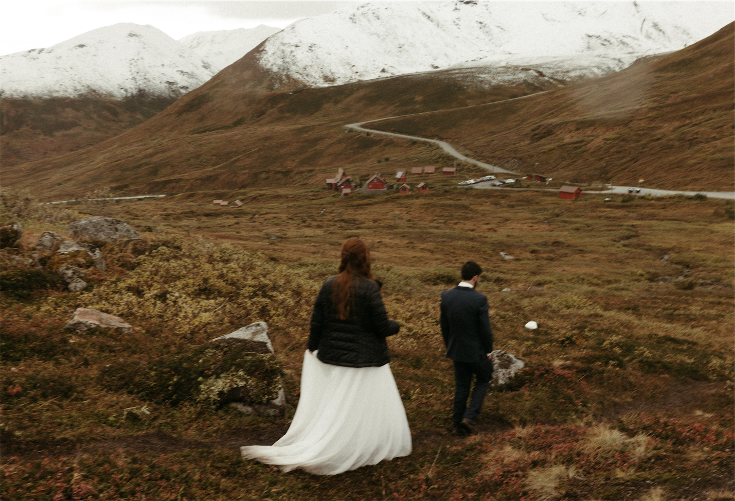 A couple walking in Hatchers while wearing wedding attire. 