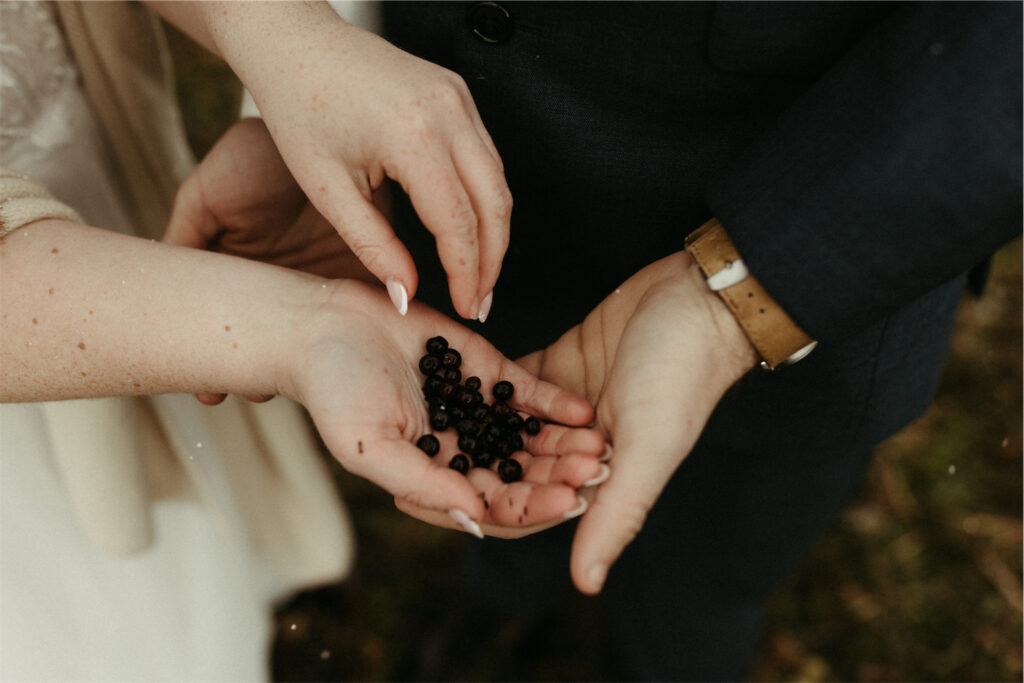 Couple holding blueberries in their hands 
