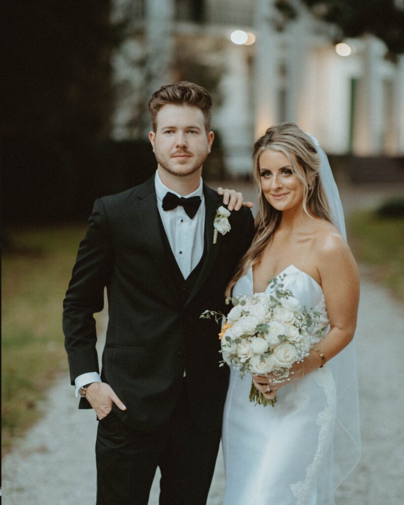 Bride and groom standing outside Riverwood Mansion in Nashville