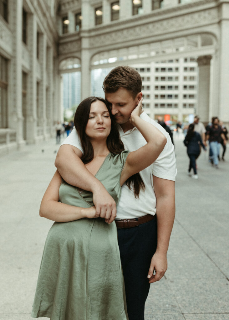 Couple snuggled together while taking engagement photos in Chicago 