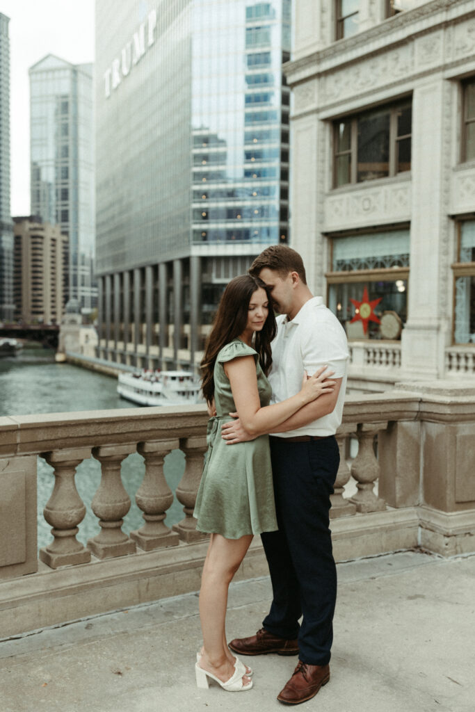 Couple standing close to one another while taking engagement photos