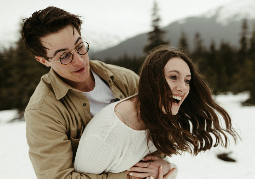 Couple snuggled close while taking engagement photos in Alaska