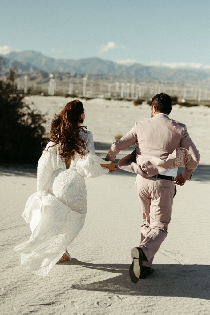 Man and woman running away together after their Palm Springs elopement 