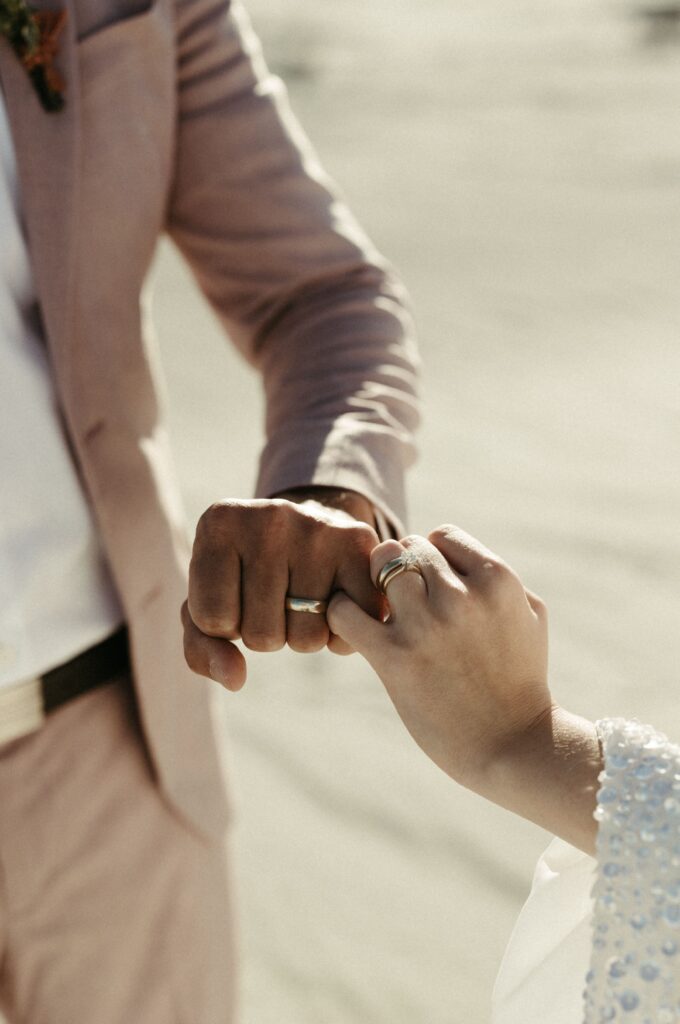 Man and woman showing off their new rings after their California elopement 