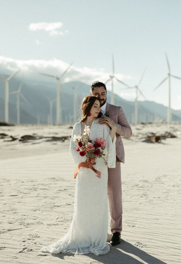 Couple holding onto one another during their California elopement