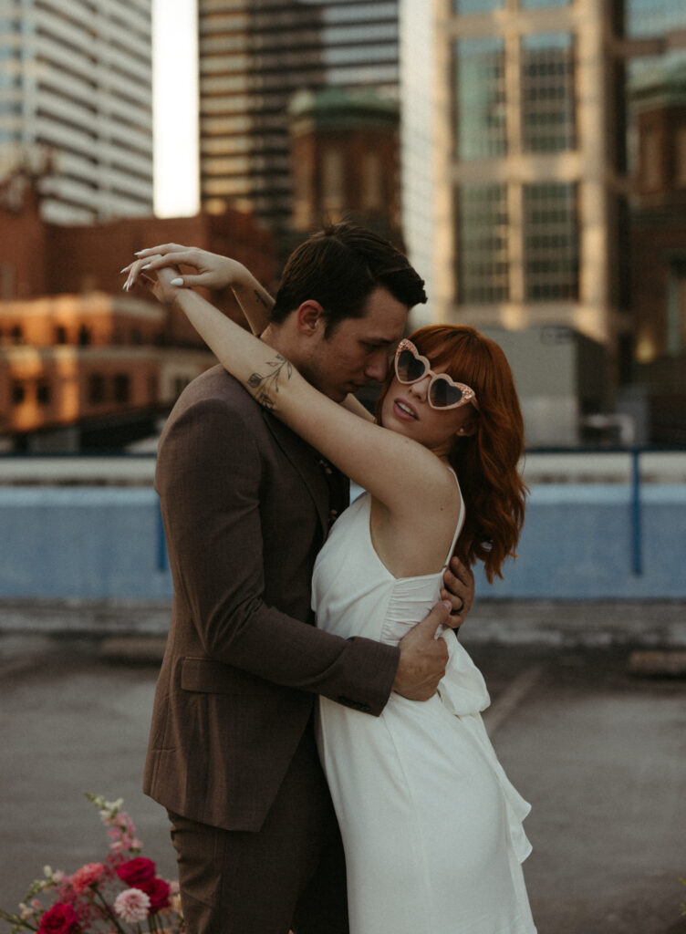 Woman wearing heart shaped sunglasses and a wedding dress in Nashville