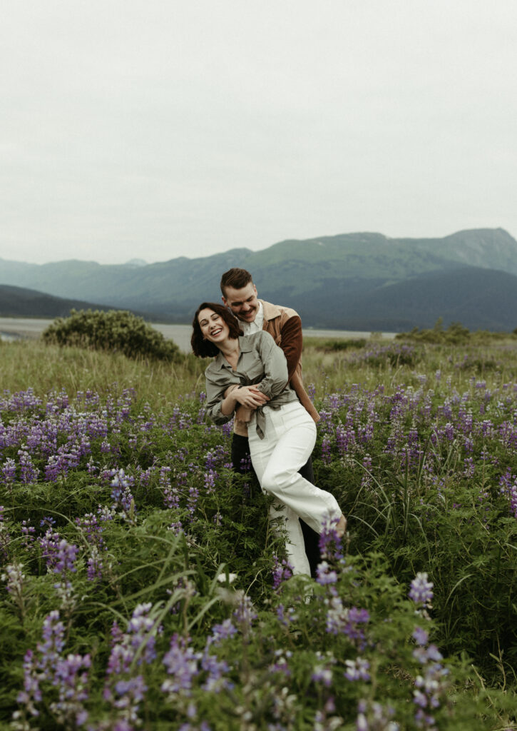 Couple holding eachother during their engagement photo shoot in Alaska 