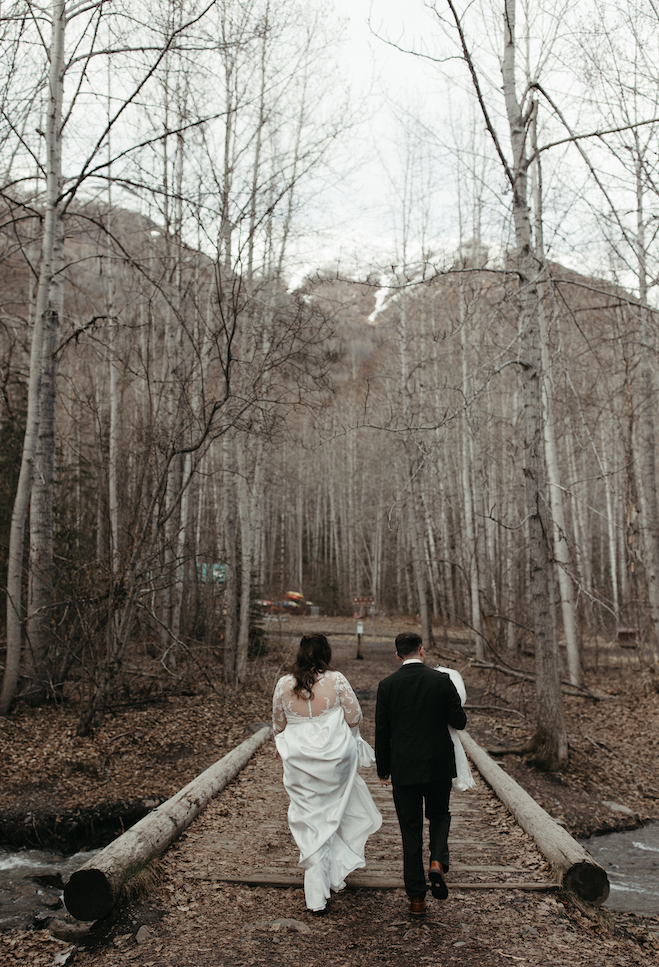 Couple walking through the woods during their elopement. 