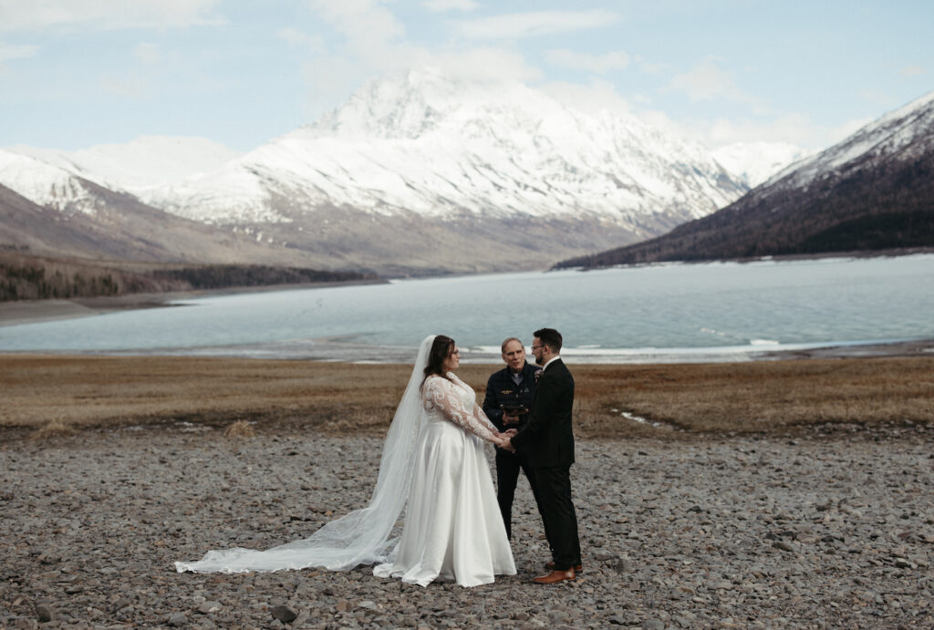 Couple and their officiant during their elopement at Eklutna Lake. 