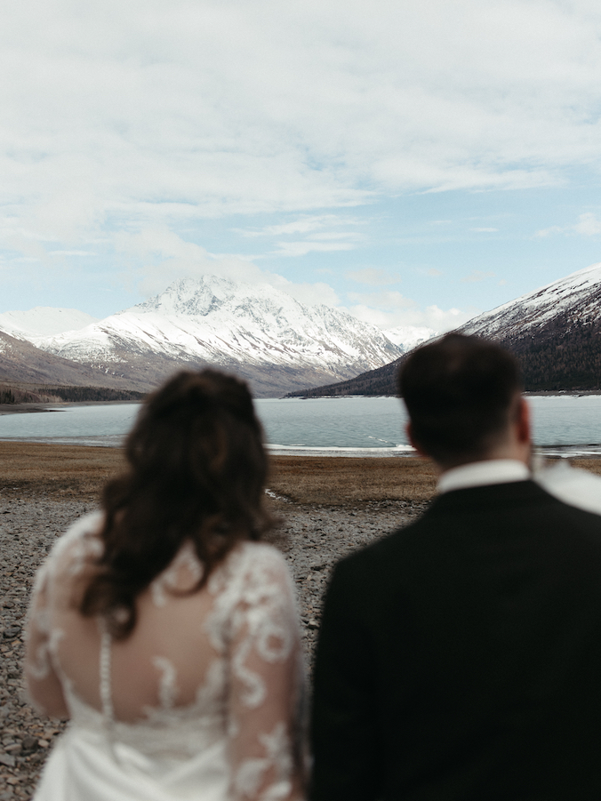Couple taking in views of the mountains at Eklutna Lake. 