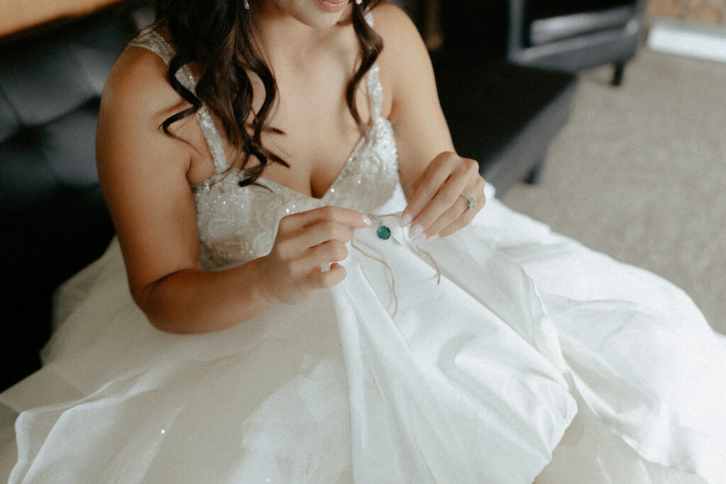 Woman holding a necklace and getting ready to place around her neck.