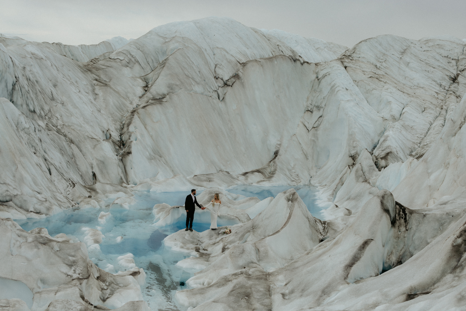 Couple holding hands while standing on ice