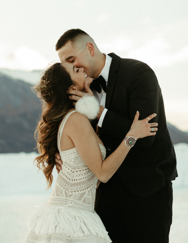 Man holding a woman's face and kissing her cheek