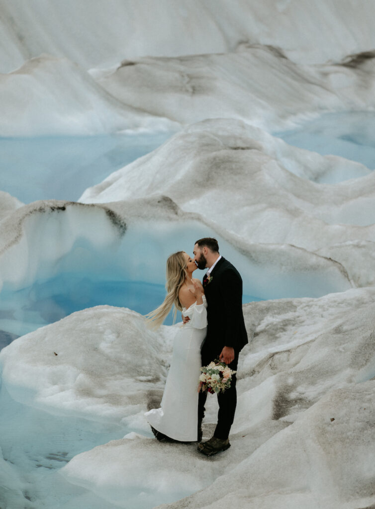 Couple kissing while on a glacier