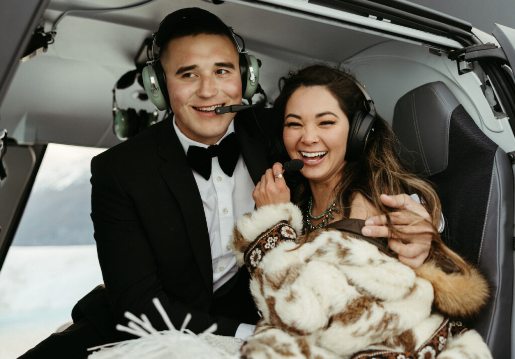 Couple wearing headsets and smiling at one another