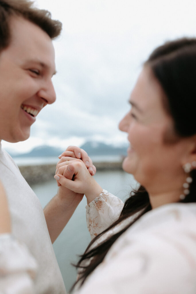 Man and woman holding hands and looking at one another