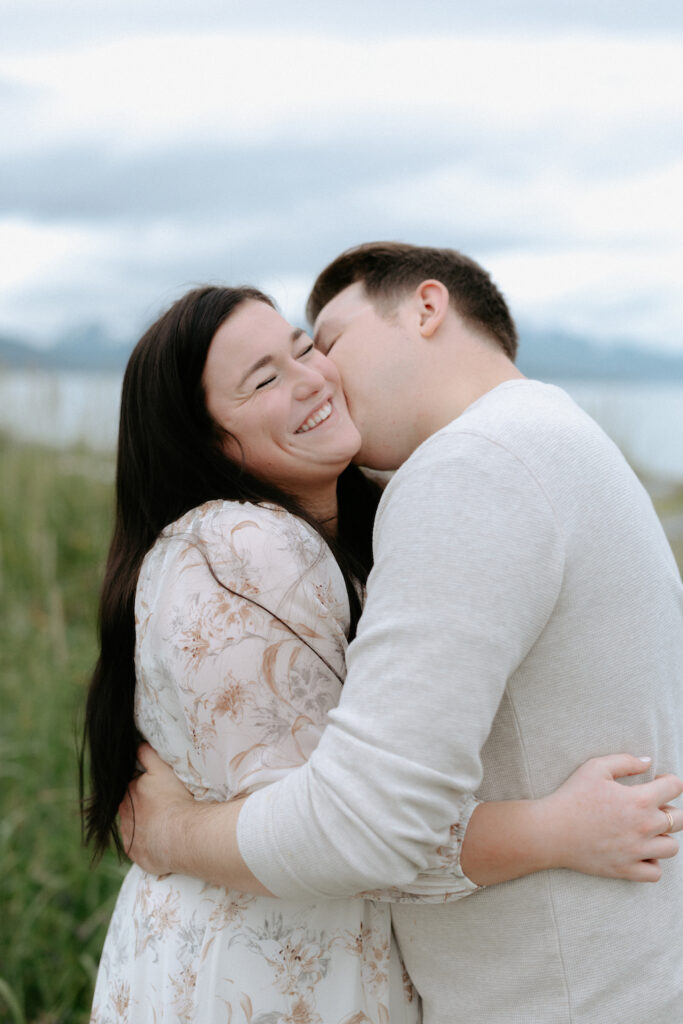 Man kissing the far side of a woman's face