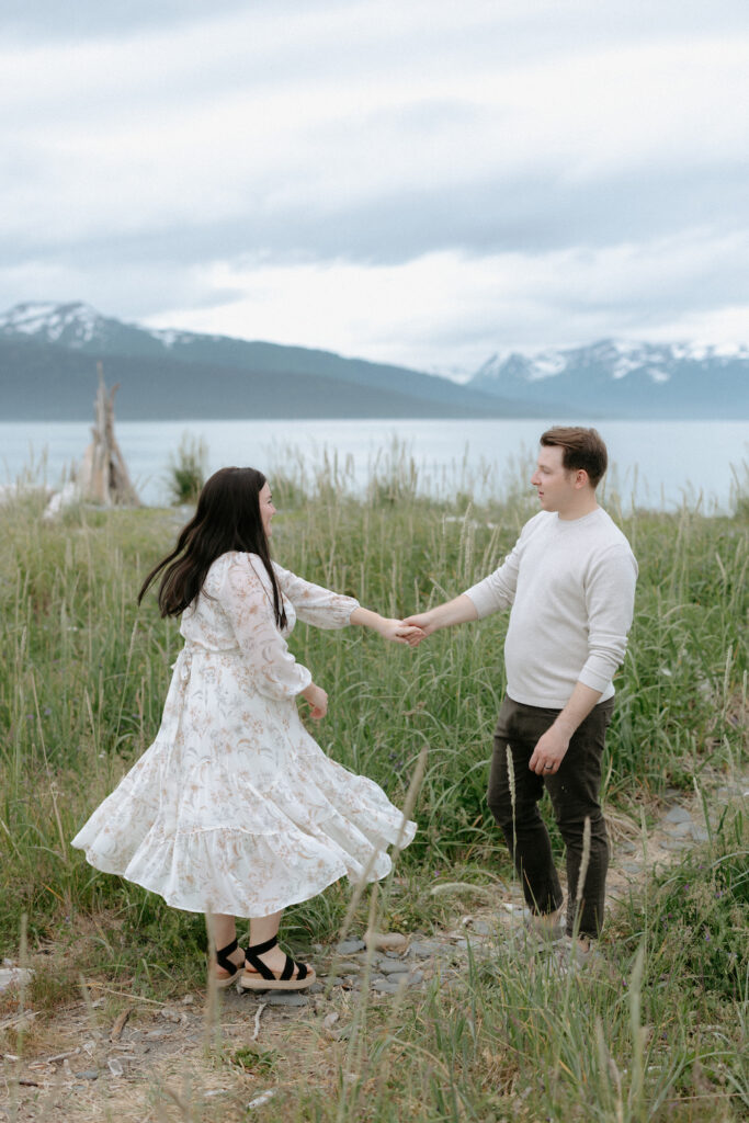 Man spinning woman around who is wearing a flowy dress