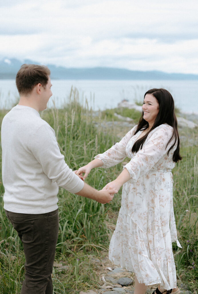 Couple holding hands and spinning around in a circle