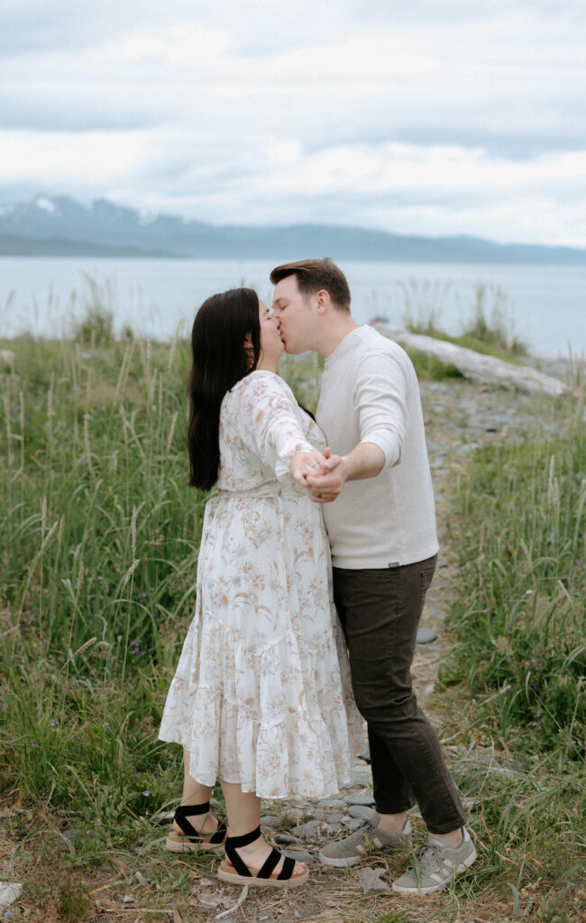 Couple kissing while holding hands