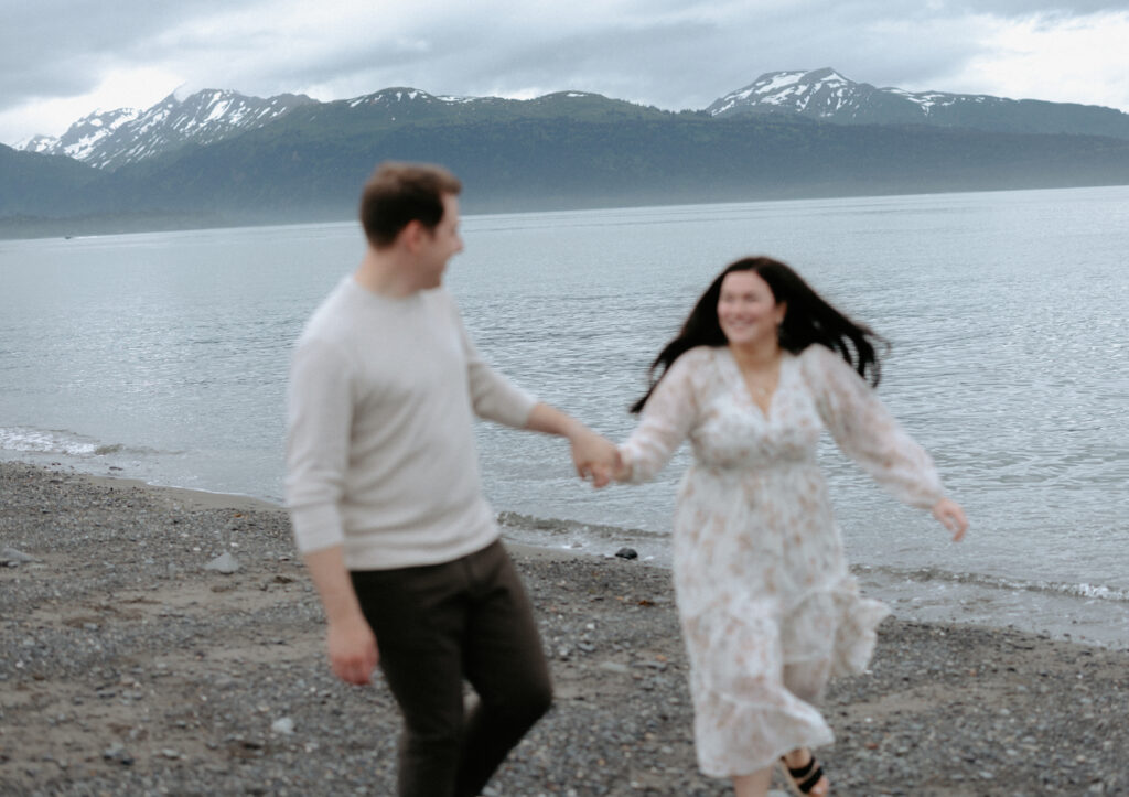 Man and woman running along the beach