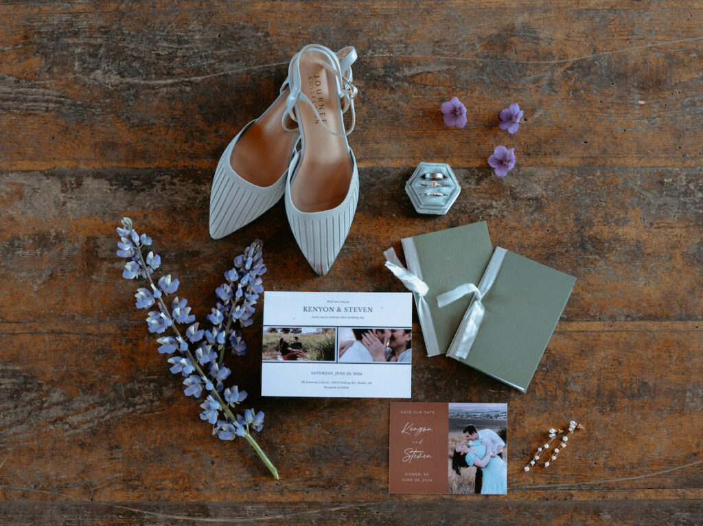 Special items from the couple laid out on a wooden floor inside an Alaska wedding venue.