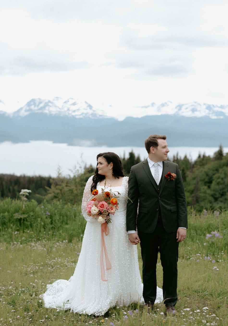 Couple looking in opposite directions while wearing wedding attire.