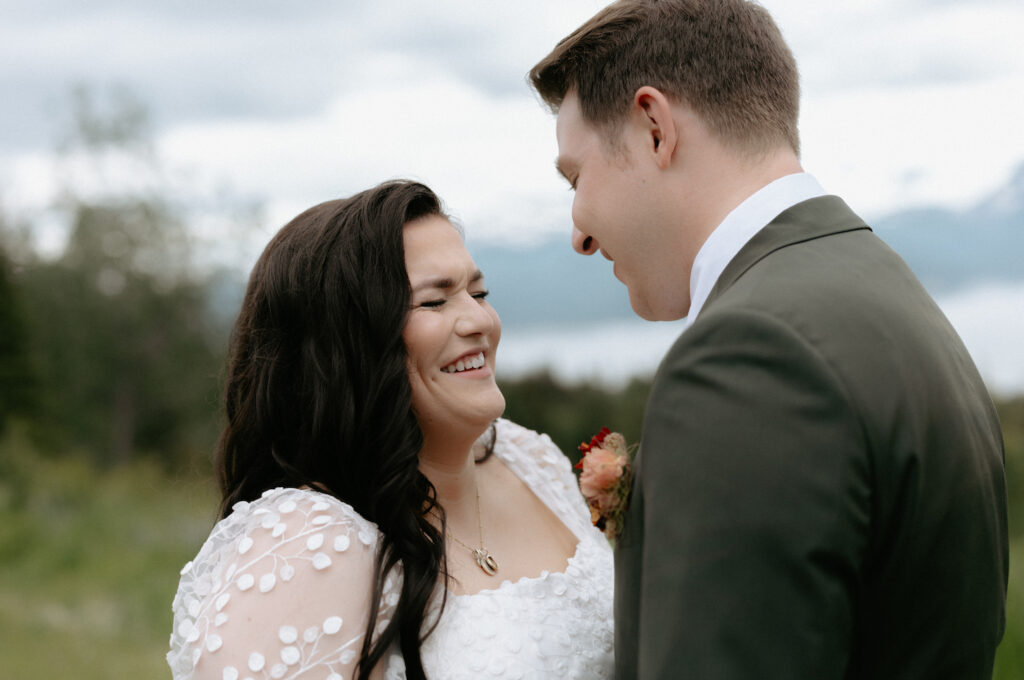 Woman smiling while standing next to a man.