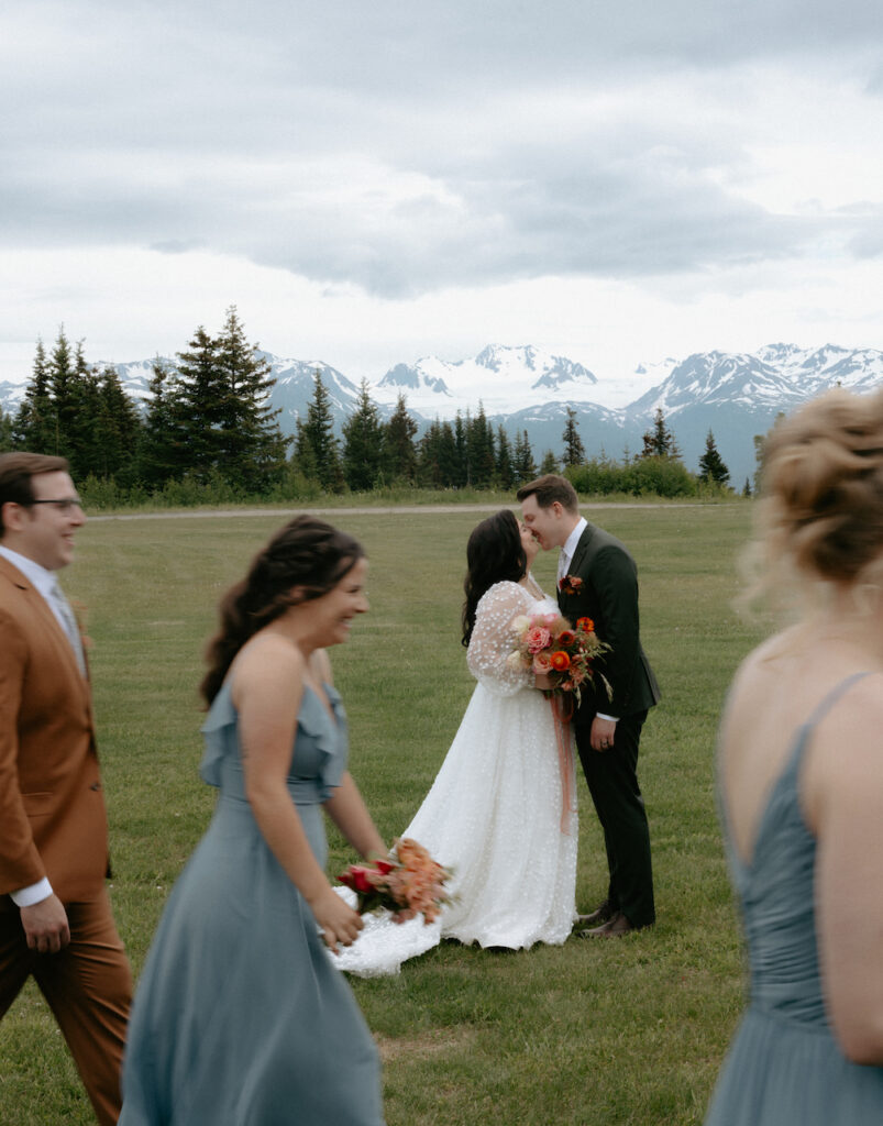 People walking in front of a couple on their wedding day.