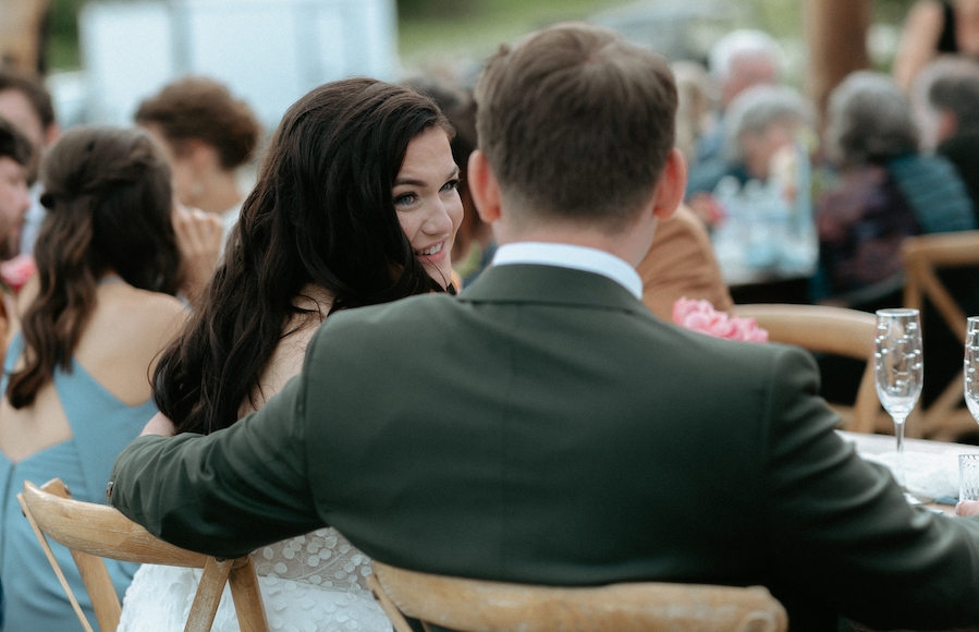 Couple looking at one another during toasts.