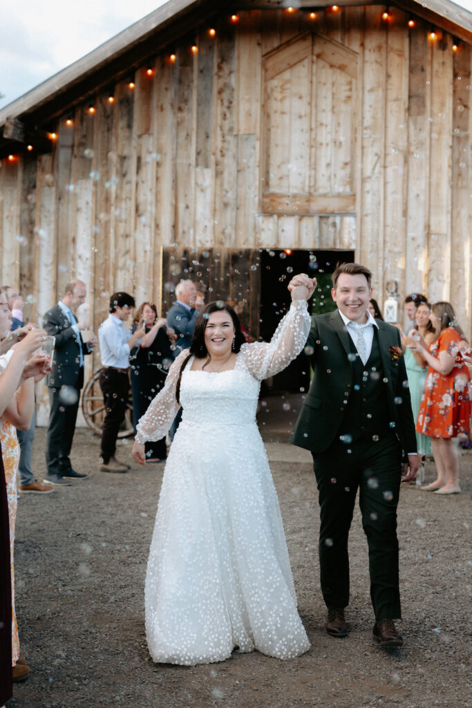 Couple walking away from a barn and stepping into a bubble exit